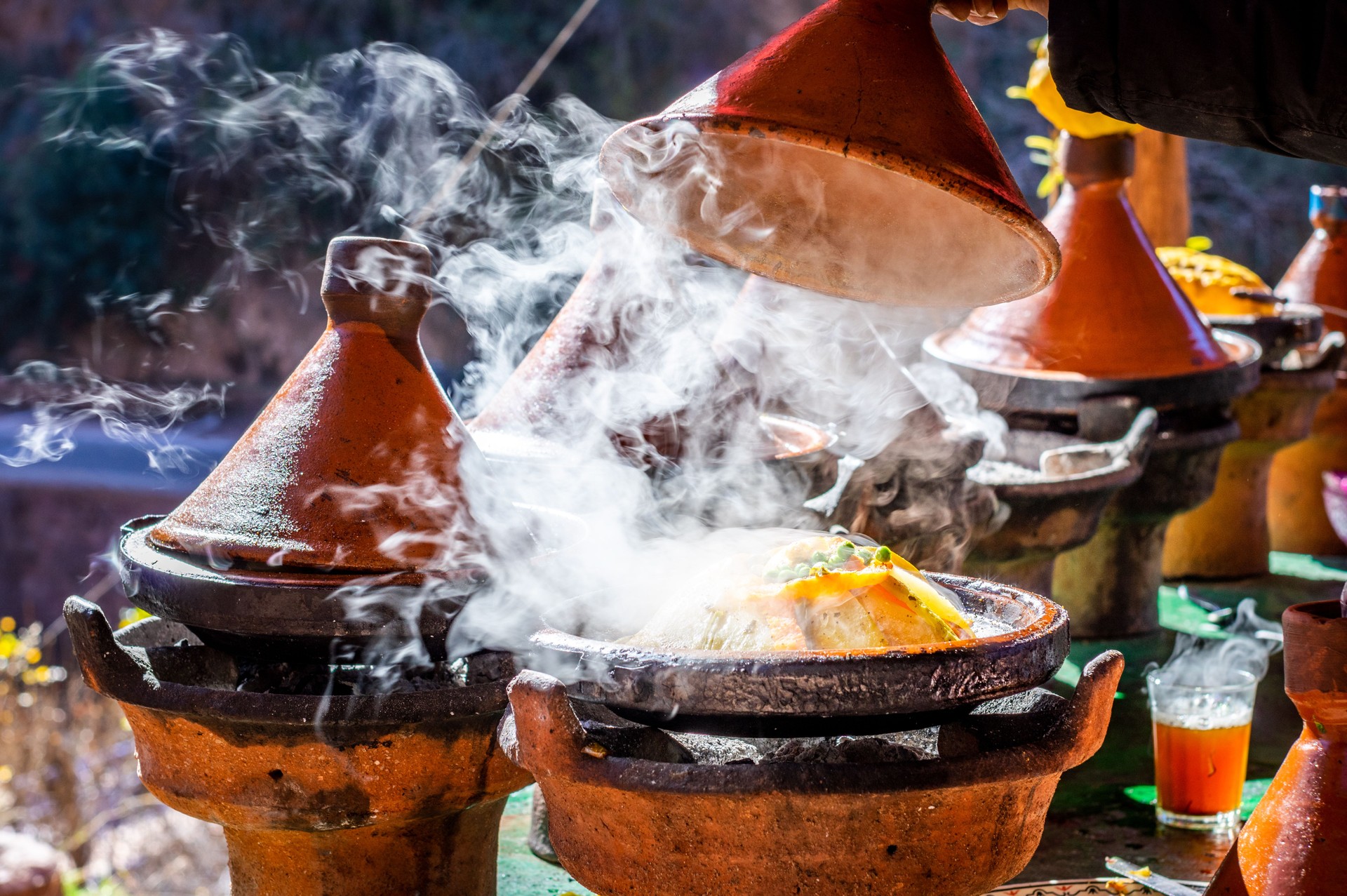 Traditional Moroccan chicken tajine with chickpeas and vegetables in a hot plate